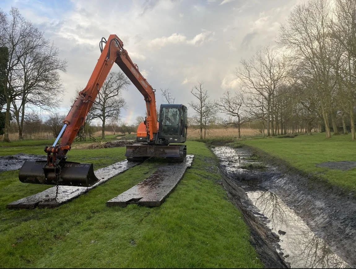 Digger dredging pond